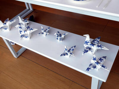 Table with multiple origami cranes of various sizes