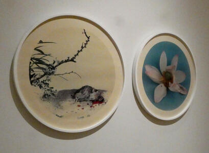 two circular artworks dead quail and flower