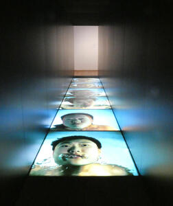 Several large photos embedded in floor showing a man underwater.