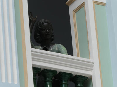 statue of woman on balcony