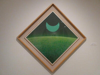 Diamond-shaped picture frame with green crescent moon above green lawn