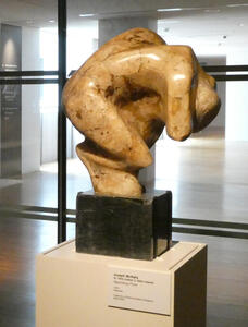 marble sculpture of man crouched over.