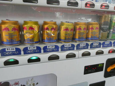 small red bull cans in vending machine