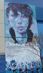 Very large wall painting of young woman.