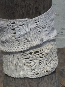 White yarn knitted around base of tree.