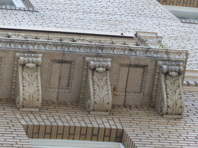 Stone scrollwork on supports under building overhang