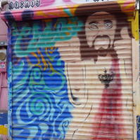 Shopfront with spray-painted Jesus giving a thumbs up