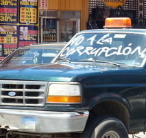 Truck with “No to corruption” painted on windshield