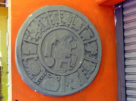 Circular stone emblem with aztec motif