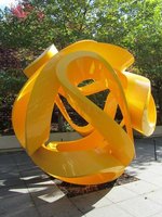Bright yellow twisted plastic, spherical-shaped sculpture