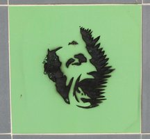 green tile with spray-painted laughing man