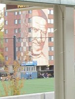 Facade of school showing large picture of Catholic cleric.