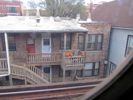 Apartment building near subway with pumpkins on balcony