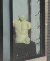 Sculpture of male torso in a display window