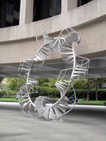 Spiral metal sculpture in shape of large wheel
