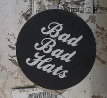 Sticker on street sign: Bad Bad Hats