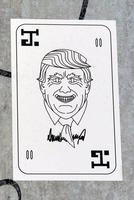 Sticker showing “Joker” playing card with line drawing of Trump