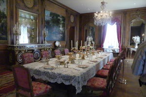 Dining room with candelabras on table and fine place settings
