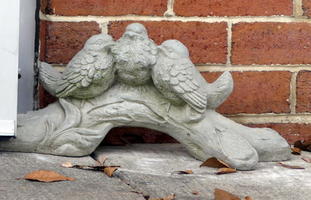 Concrete doorstop in form of an angel.