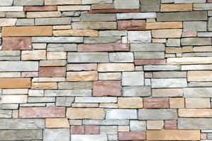 Wall of multi-colored slightly irregular rectangular stones