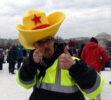 Man wearing large yellow foam cowboy hat