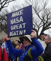 Man holding sign “Make NASA Great Again!”