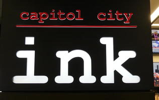 Sign reading “capitol city ink”