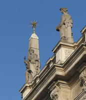 Statuary and mace-like star on top of building