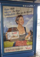 Woman in dirndl holding jar labeld “heidi” in Nutella font and coloring