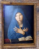 Woman in blue shawl, hands crossed over heart