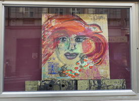 Slightly abstract painting of woman with red hair and orange necklace