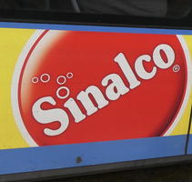 Bubbles emerging from dot over “i” in Sinalco