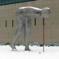 Sculpture of a man bending over at 90 degree angle