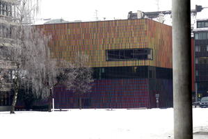 building with many thin multicolored stripes on exterior