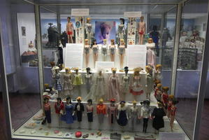 Display case of Barbie dolls with two Ken dolls