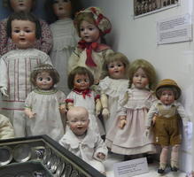 Collection of somewhat creepy dolls, one in lederhosen.