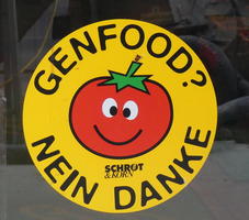 Circular sticker; smiling tomato in center