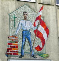 mosaic of man standing next to a stack of bricks; has Austrian flag in right hand.