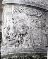 Women bathing child; carving detail on column