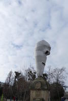Large white larva-like sculpture on bridge