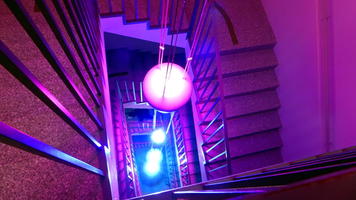Purple and blue lighting fixture in stairwell
