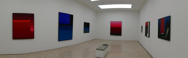 Panoramic view of room with colored abstracts