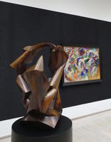 Abstract bronze in foreground, painting in background