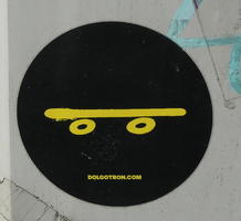 Sticker of stylized yellow skateboard on black background