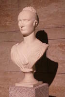 Bust of severe looking woman with short curly hair