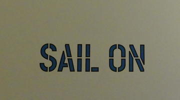 Stenciled in English: “Sail on”