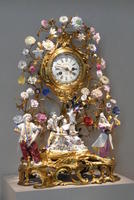 Baroque clock surrounded by procelain flowers