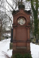 Brown grave marker from 1870s with large cameo of man