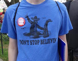 T-shirt of Bigfoot riding Loch Ness Monster: “Don't stop believin'”