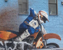 Realistic painting of motorcycle racer in helmet and padding